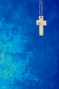Cross on blue wall background Royalty Free Stock Photo