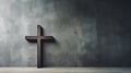 A wooden Christian cross near a concrete wall