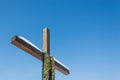 Wooden christian cross with Ukrainian flag color ribbons on the plain blue sky background, Concept of hope, freedom Royalty Free Stock Photo