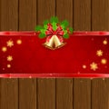 Wooden Christmas background with red bow and bells Royalty Free Stock Photo