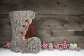 Wooden christmas background in red and grey with santa boot. Royalty Free Stock Photo