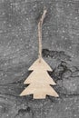 Wooden christmas carved tree - shabby style on a grey background