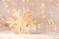 Wooden christmas decoration shaped as a snowflake with text World of Winter and soft bokeh of yellow christmaslights Royalty Free Stock Photo