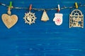 Wooden Christmas decorations and Christmas lights on the blue wooden background. Royalty Free Stock Photo