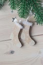 Wooden Christmas decorations - Christmas socks on a white wooden background with a Christmas tree Royalty Free Stock Photo
