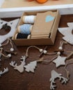 Wooden Christmas decorations handmade. Head of a deer, Christmas trees and stars. Kraft box with ribbons