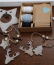 Wooden Christmas decorations handmade. Head of a deer, Christmas trees and stars. Kraft box with ribbons