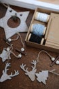 Wooden Christmas decorations handmade. Head of a deer, Christmas trees and stars. Kraft box with ribbons