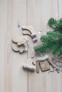 Wooden Christmas decorations - Christmas mittens, hat, sweater and socks on a white wooden background with a Christmas tree Royalty Free Stock Photo