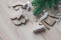 Wooden Christmas decorations - Christmas mittens, hat, sweater and socks on a white wooden background with a Christmas tree