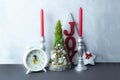 Wooden christmas tree and heart, red and white candlesticks on white door background. Christmas decoration