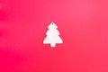 Wooden Christmas tree toy on a red background. Natural Christmas decor concept. Royalty Free Stock Photo