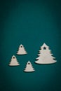 Wooden Christmas trees on Christmas green background