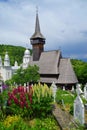 The wooden church from Botiza. `All Saints` Sunday` church in the background. Maramures County.