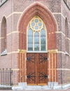 Wooden church door with large black metal hinges Royalty Free Stock Photo