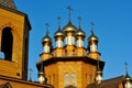 The wooden Church with the Golden domes against the blue sky. Russia, Belgorod. Royalty Free Stock Photo