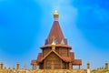 Wooden Church with Golden domes against the blue sky Royalty Free Stock Photo