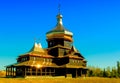 Wooden church with golden domes. Royalty Free Stock Photo