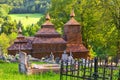 Wooden church of Saint Michael the Archangel in Prikra during summer with the cemetery Royalty Free Stock Photo