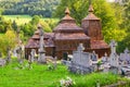 Wooden church of Saint Michael the Archangel in Prikra during summer with the cemetery Royalty Free Stock Photo