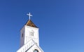 Wooden Church Steeple with Cross. White Old Church, Blue Sky On Background. Copy Space For Royalty Free Stock Photo