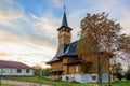 Wooden church at sunset with autumn tree and sky Royalty Free Stock Photo