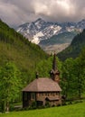 Wooden church, Tatranska Javorina, in the background peaks of the High Tatras Royalty Free Stock Photo