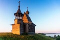 Wooden church on the top of the hill. Vershinino village sunset view. Arkhangelsk region, Northern Russia. Royalty Free Stock Photo