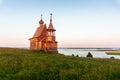 Wooden church on the top of the hill. Vershinino village sunset view. Arkhangelsk region, Northern Russia. Royalty Free Stock Photo