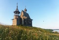 Wooden church on the top of the hill. Vershinino village sunset view. Arkhangelsk region, Northern Russia. Royalty Free Stock Photo