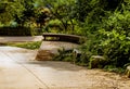 Wooden circular park bench beside concrete hiking trail Royalty Free Stock Photo