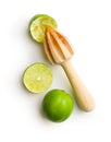 Wooden citrus squeezer and green lime