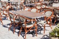 Wooden classic french chairs on cafe outdoor restaurant coffee and metal tables parisian terrace Royalty Free Stock Photo