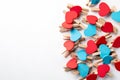 Wooden clips with red and blue heart. White background with copy space Royalty Free Stock Photo