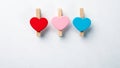 Wooden clips with Red, Pink and Blue heart. White background with copy space Royalty Free Stock Photo