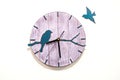 Wooden clock with birds on a white background close-up. Royalty Free Stock Photo