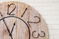 Wooden clockface on white wall