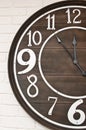 Wooden clockface on white wall