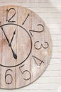 Wooden clockface on white wall