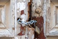 Wooden closed door background texture. Peeled board plank with chain and rusty padlock. Closeup view Royalty Free Stock Photo