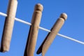 Wooden clothes pegs on a washing line Royalty Free Stock Photo