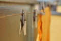 Wooden clothespin peg hanging on the balcony string as a symbol of washing clothes at home Royalty Free Stock Photo