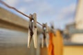 Wooden clothespin peg hanging on the balcony string as a symbol of washing clothes at home Royalty Free Stock Photo