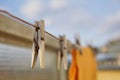 Wooden clothespin peg hanging on the balcony string as a symbol of washing clothes at home Royalty Free Stock Photo