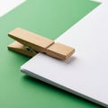 A wooden clothespin securely holds a stack of white papers. The background features Royalty Free Stock Photo