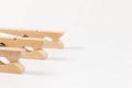Wooden clothespins with a metal spring on the background of a white wooden table. close-up. selective focus Royalty Free Stock Photo