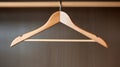 A wooden coat hanger hanging from a ceiling