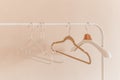 Wooden coat hangers on clothes rail. Royalty Free Stock Photo