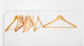 Wooden coat hangers on clothes rail Royalty Free Stock Photo