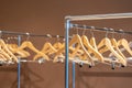 Wooden coat hangers on coat rack with no clothes in cloakroom Royalty Free Stock Photo